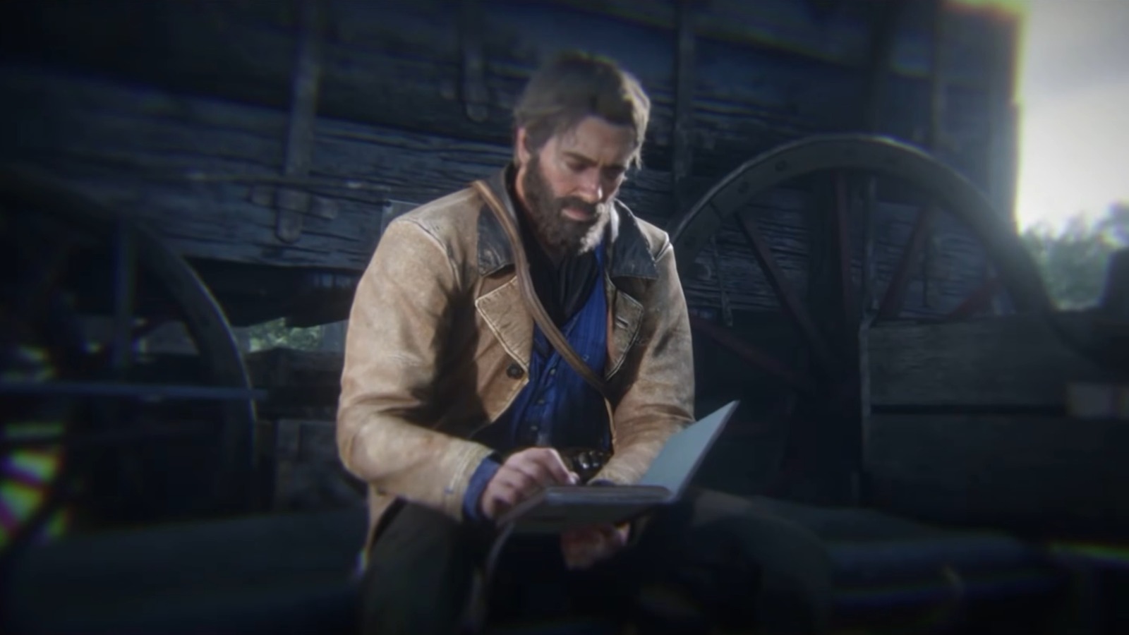 Arthur Morgan sentado lendo um diário em cena de Red Dead Redemption 2